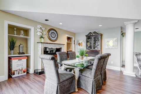 a living room with a table and chairs and a fireplace